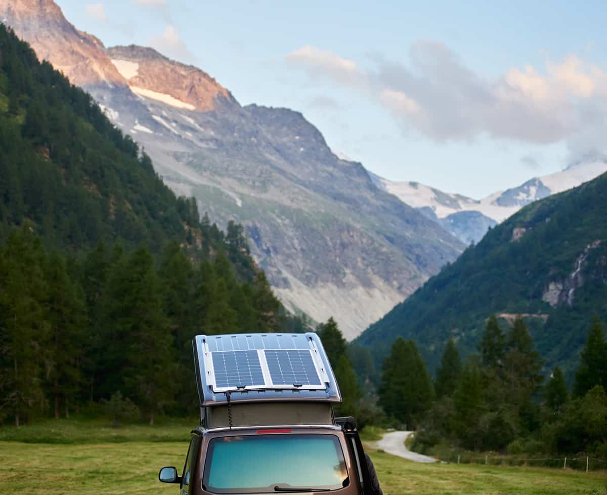 Cropped snapshot of a camper with solar modules on the roof