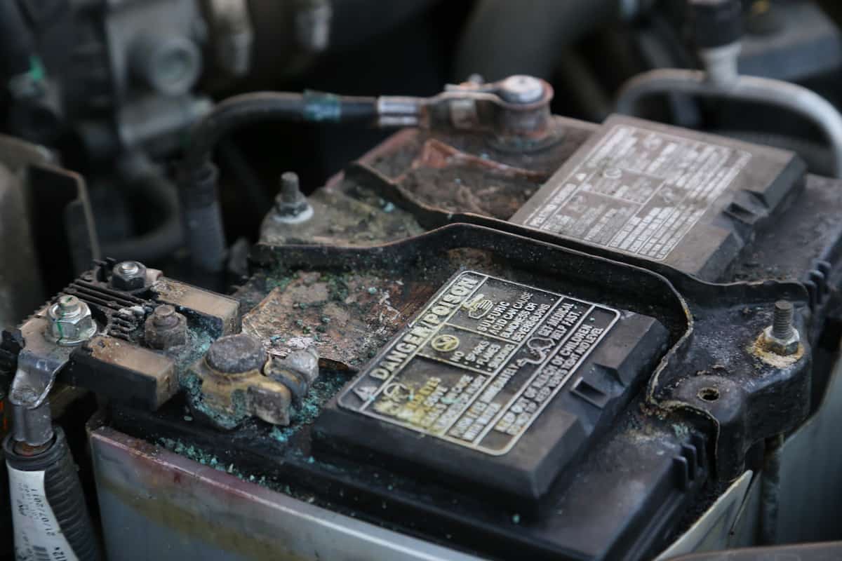 Damaged and coroded car battery danger