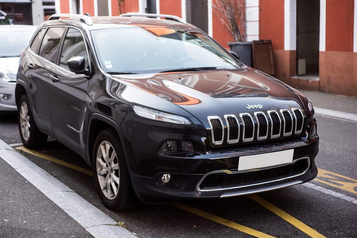 Front view of black Jeep Cherokee parked in the street