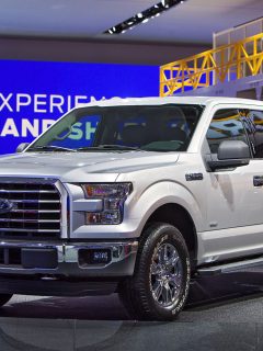Huge white Ford F150 at a car show, Should I Level My Truck? [Pros and Cons]