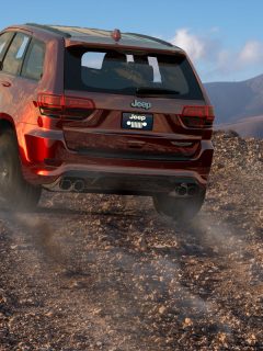 Jeep Grand Cherokee Trackhawk driving on a mountain desert road, Jeep Cherokee Water Leak When It Rains - What To Do?