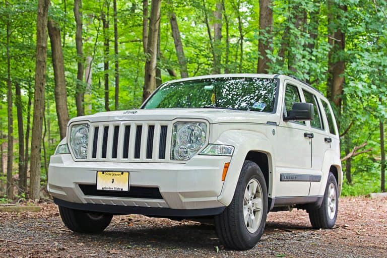 Jeep Liberty parked in a wooded area which is used by off-road enthusiasts to test the capabilities of their vehicles, Jeep Liberty Blower Motor Not Working - What Could Be Wrong?