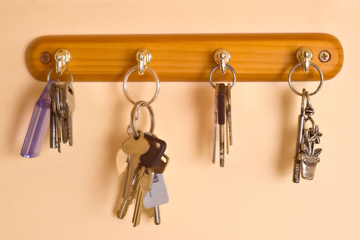 Keys hanged on the keyholder mounted on the wall