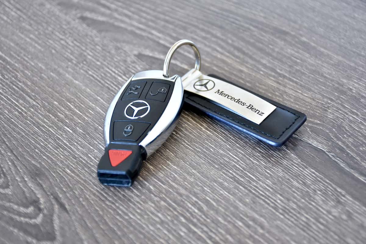 Luxury car keys on wood surface