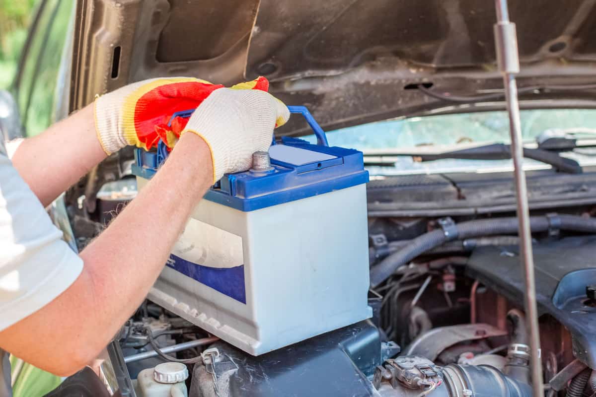 Man removing the car battery