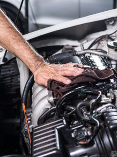 Mechanic cleaning the engine with a cloth, How To Remove Caked-On Grease And Sludge From Engine