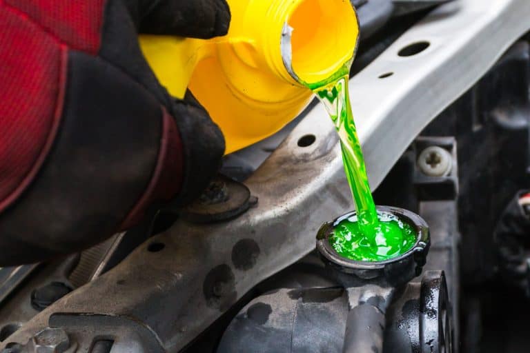 Mechanic pouring green coolant to the car engine, What Happens If You Mix Coolant Colors?