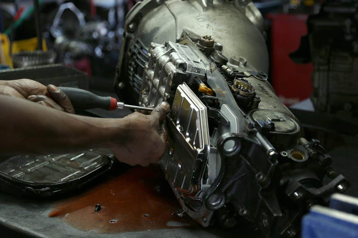 Mechanic working on car transmission