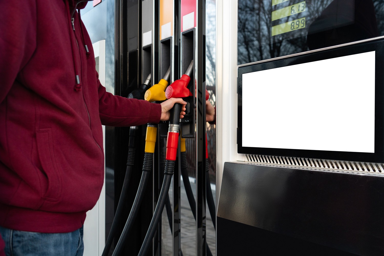 Self-service filling station. A man using a touchscreen