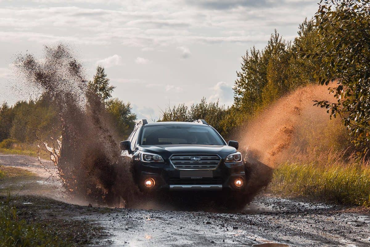 September 9, 2017 Subaru outback suv rides through a puddle with spatter