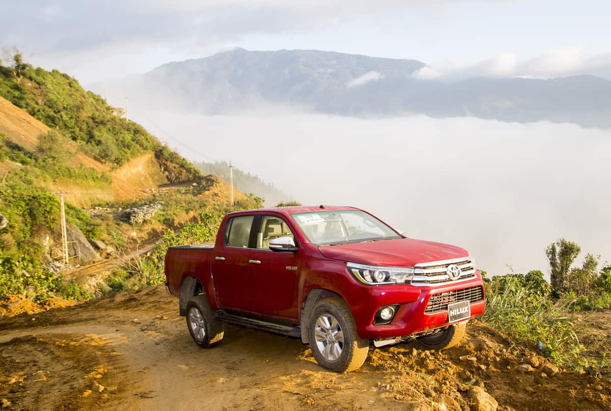 Toyota Hilux 2016 pick-up car running on the mountain road in test drive