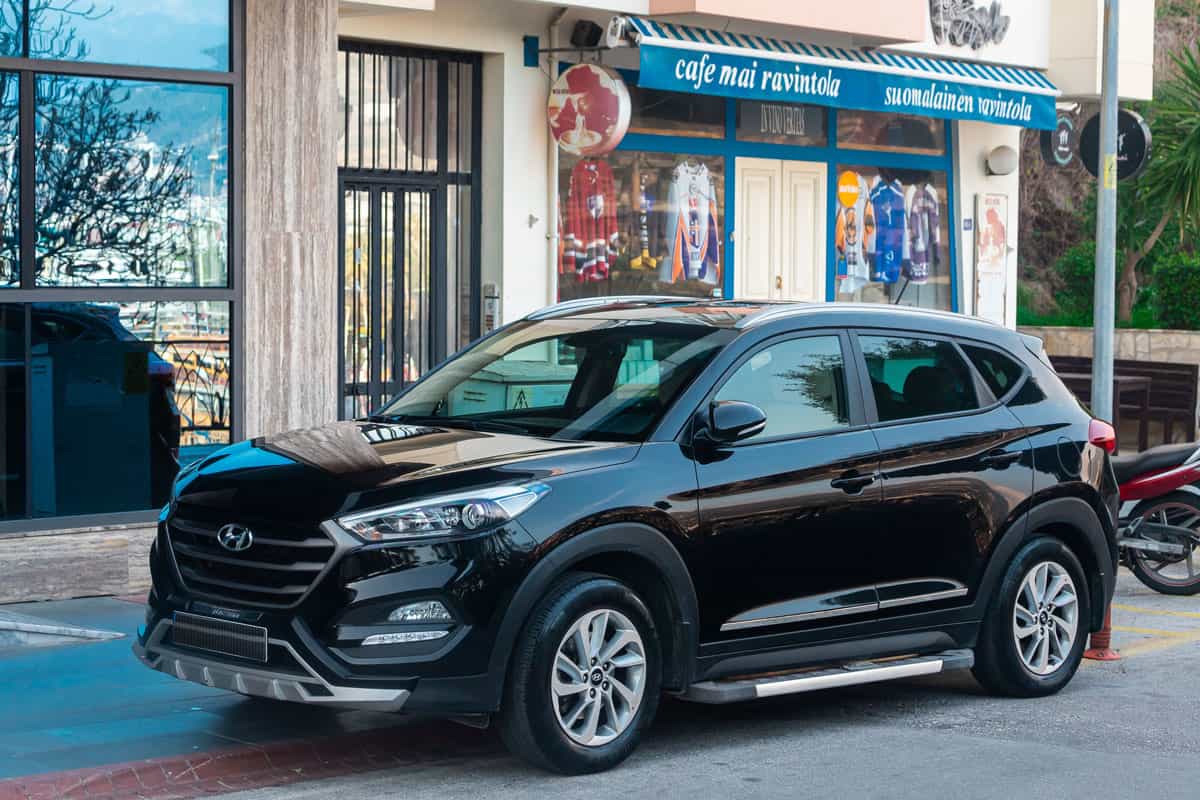 black Hyundai Tucson is parked on the street