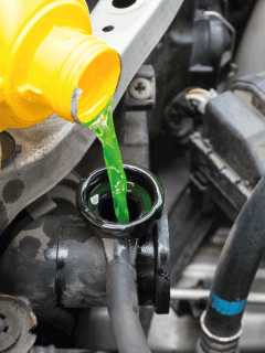 pouring-coolant-from-yellow-jug-into-car-reservoir.-What-Color-Coolant-Does-Nissan-Use