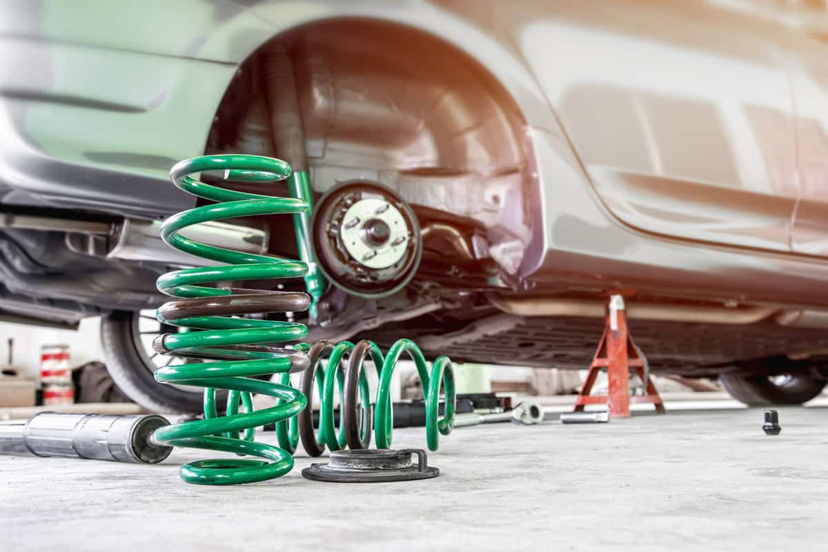 A green suspension coil spring in need of replacement