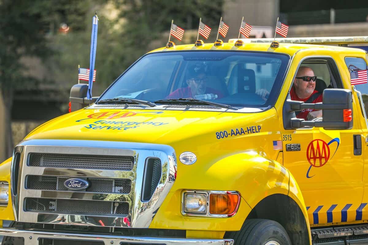 AAA (American Automobile Association) participating in the Veteran’s Day Parade on their signature tow truck.