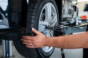 Auto mechanic installing new car tires, Why Do New Car Tires Wear Out So Fast?