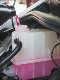 Auto mechanic pouring pre-mixed super long life coolant fluid in coolant reservoir tank, How Long Can You Drive With Mixed Coolant?