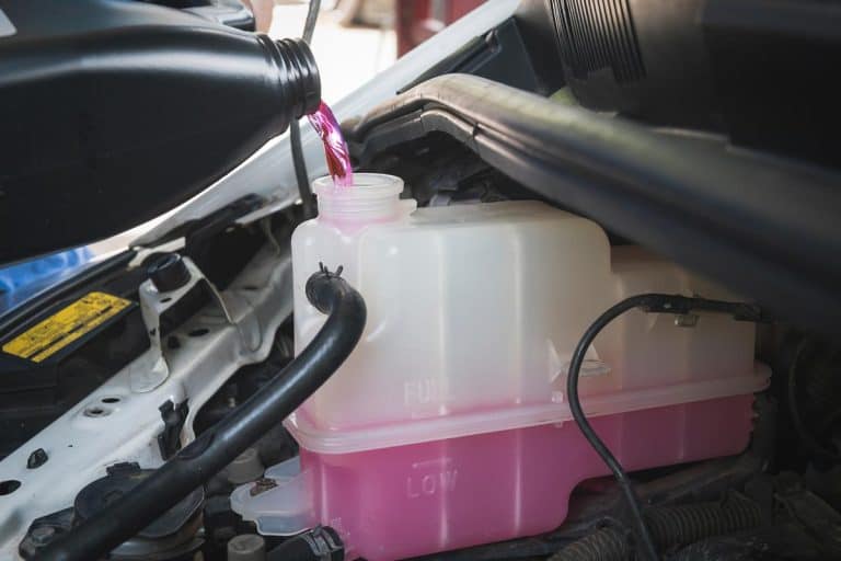 Auto mechanic pouring pre-mixed super long life coolant fluid in coolant reservoir tank, How Long Can You Drive With Mixed Coolant?