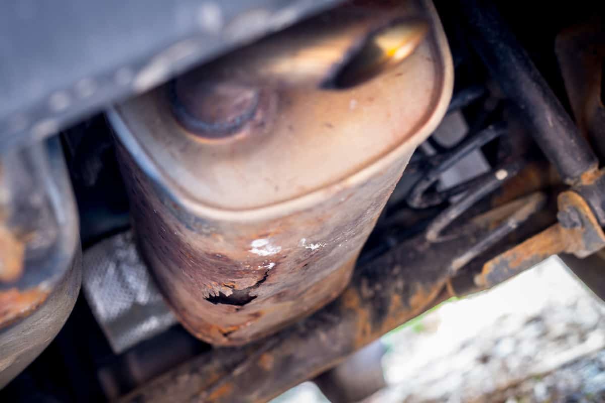 Close up of old and rusty exhaust pipe of a car
