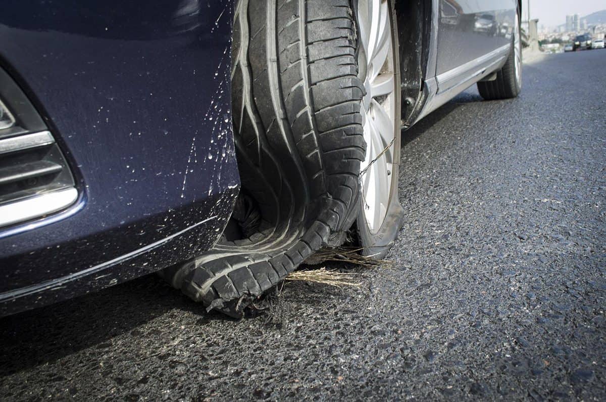 Damaged tire after tire explosion at high speed on highway