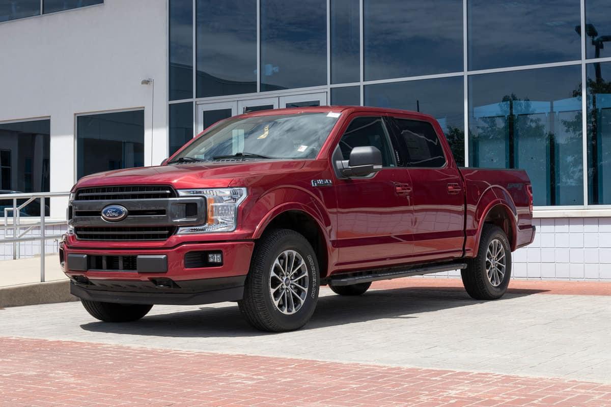 Dark red colored Ford F-150 at a Ford Dealership