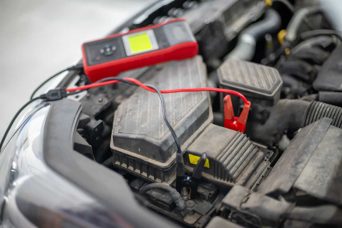 Digital measuring device testing the car battery