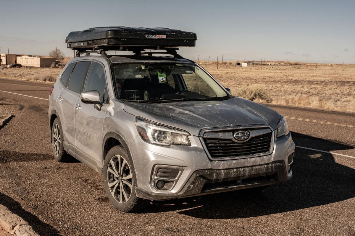 Dirty Subaru Forester With Roof Top Tent at Petrified Forest National Park after driving through a winter storm