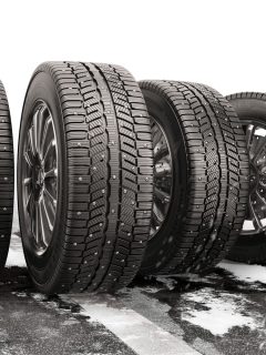 Four car tires rolling on a snow-covered road - How To Remove Studs From Tires