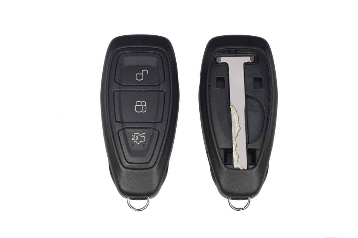 Keyless car key fob showing front and back with panel removed to show emergency key
