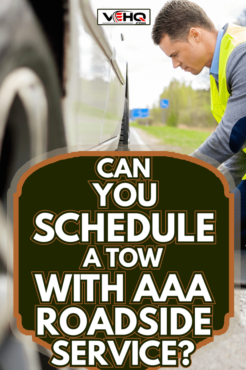 Man changing wheel on a roadside - Can You Schedule A Tow With AAA Roadside Service