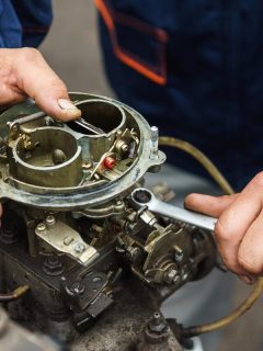 A mechanic repairing the carburetor, How To Prime A Carburetor