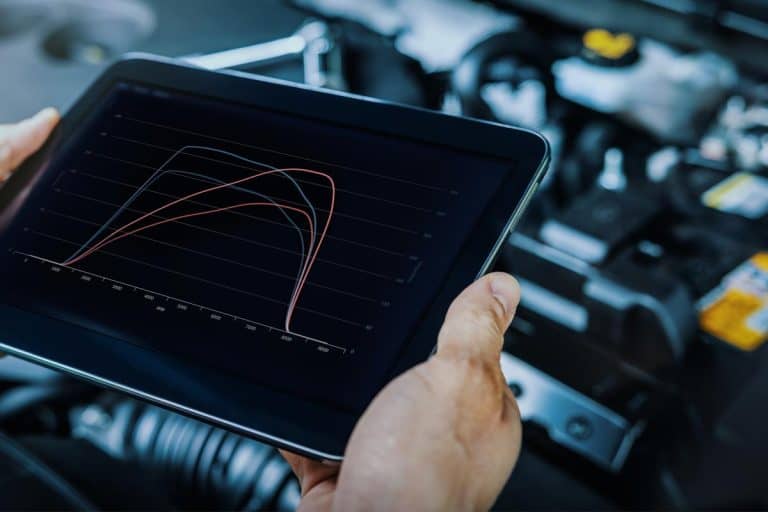 A mechanic using digital tablet to check vehicle performance after chiptuning, Does The ECU Have To Match The Engine?
