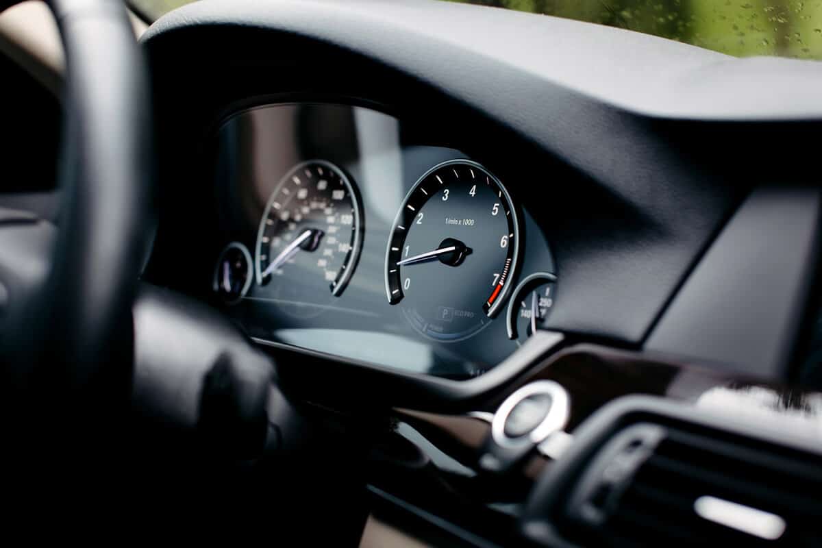 Modern mileage car dashboard instrument panel interior. Miles Speedometer.
