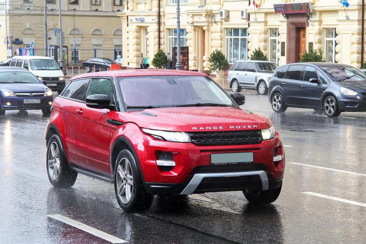 Red crossover Range Rover Evoque in the city street.