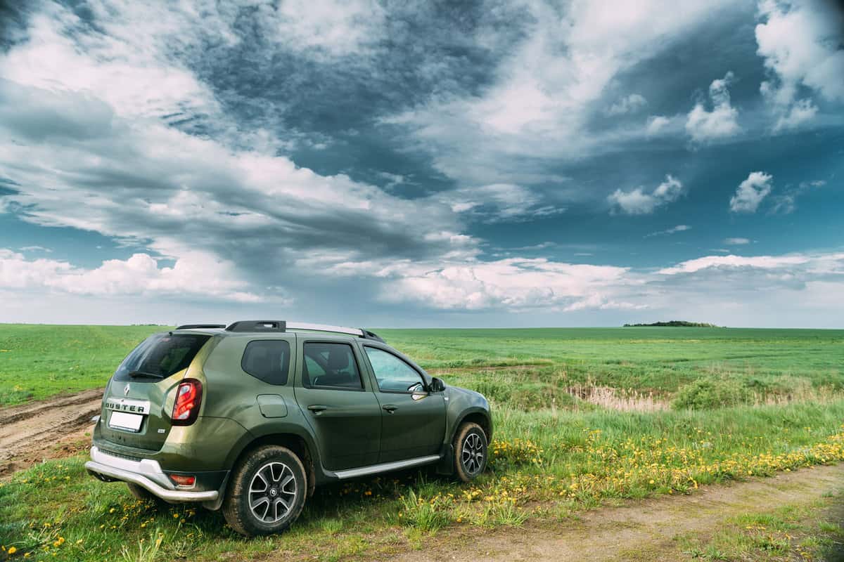Renault Duster parked on grass looking at a storm cell