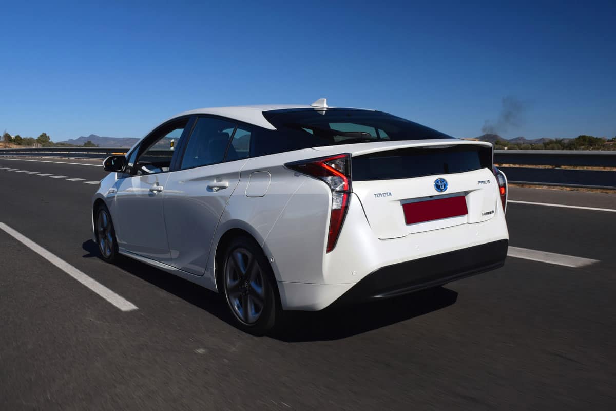 Toyota Prius driving on the highway. This model is the most popular hybrid vehicle in the world.