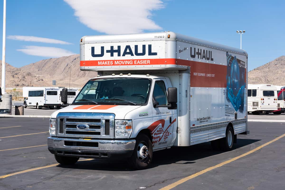 U haul truck parked in a parking lot. U-Haul is an American moving equipment and storage rental company