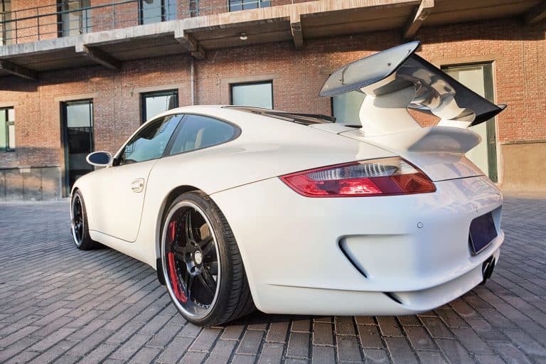 White sports car with huge spoiler installed at the back, Can You Add A Spoiler To Any Car [And Should You?]