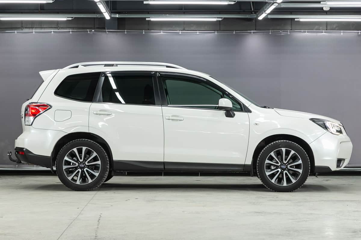 white Subaru Forester,side view. SUV car on a parking
