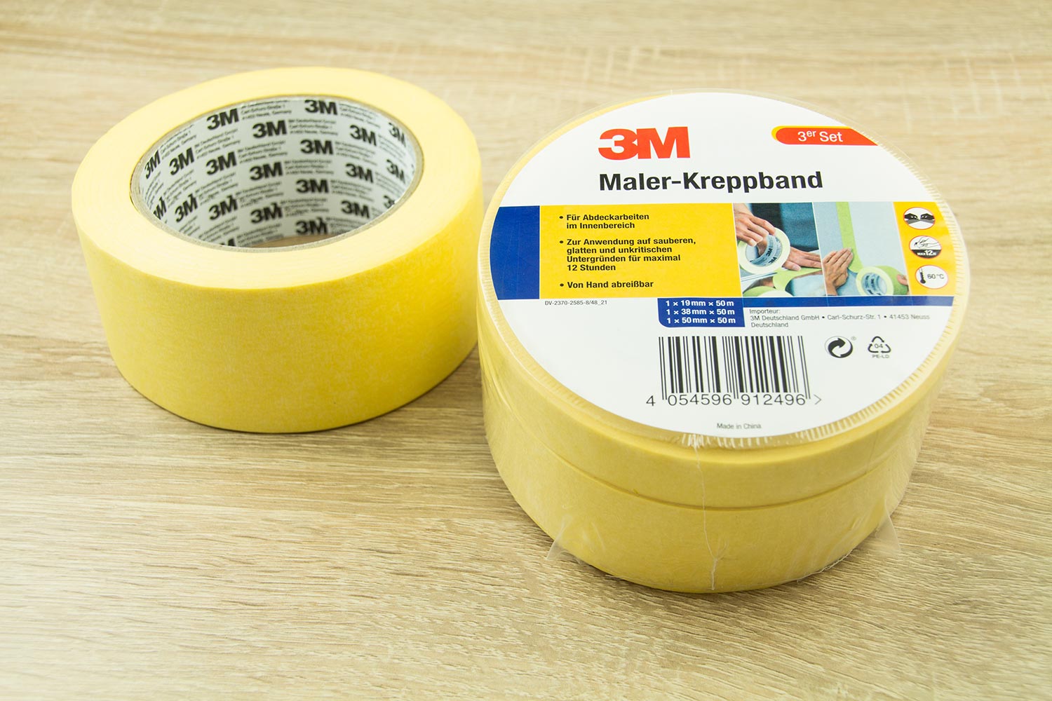 3M painters masking tape rolls on wooden background