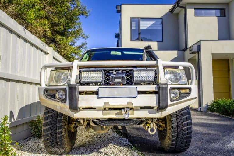 4WD truck with bull bar parked in a driveway front view, Can You Put A Bull Bar On Any Car?