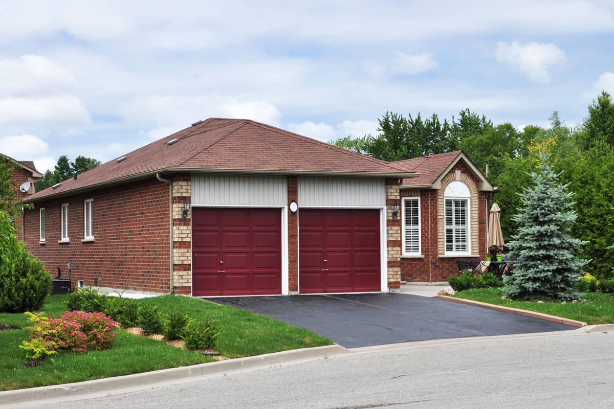 A brick house with red colored garage door