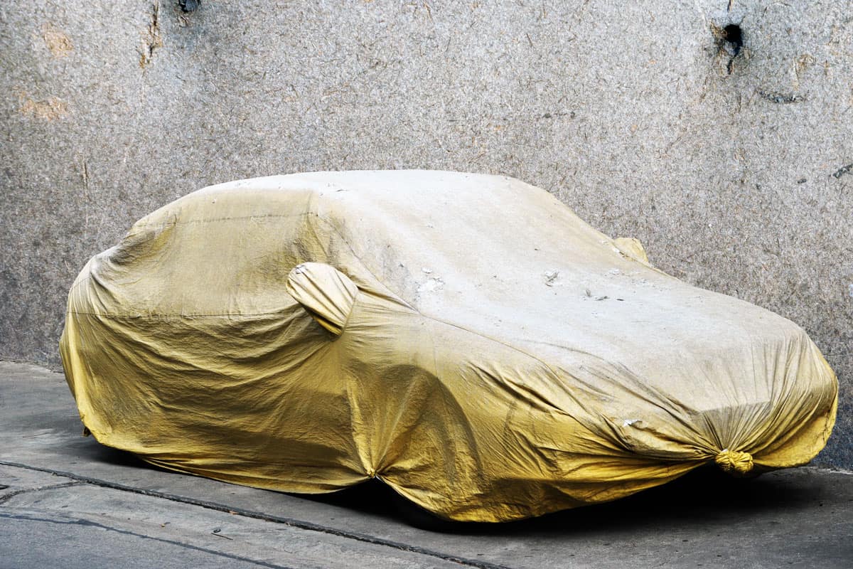 A covered car on the side of the road