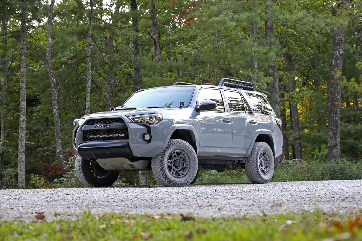 A gray Toyota 4Runner parked near a forest area