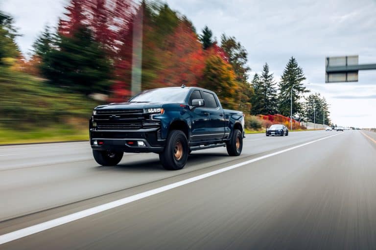 A huge black colored Chevrolet Silverado moving at the highway, What Rear End Is In My Chevy Truck? [Follow These 3 Steps To Tell]