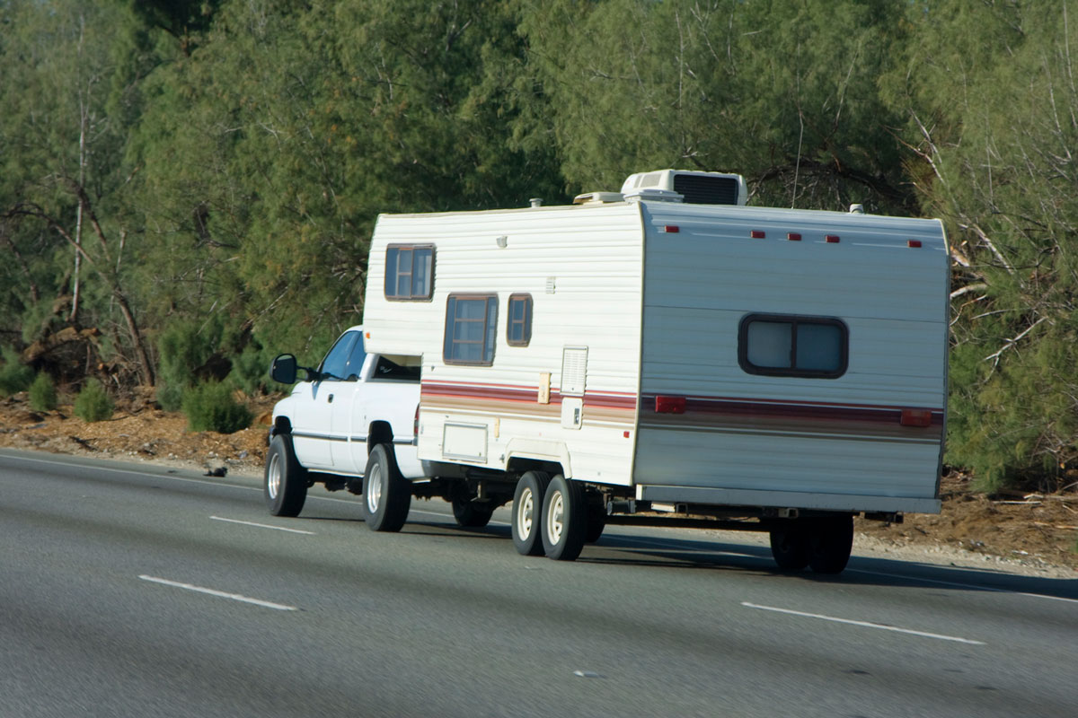 A pickup truck towing a fifth wheel camper