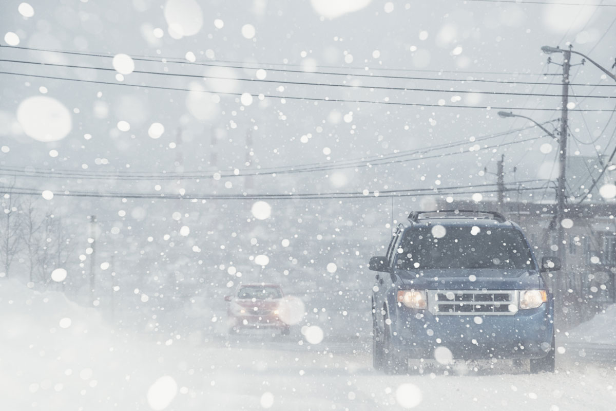 A truck moving during a heavy snow fall