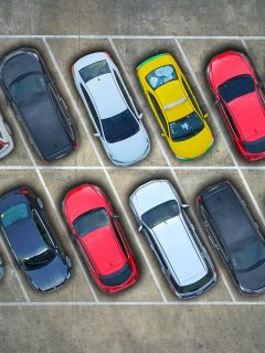 Aerial view of cars in a parking lot. - What Cars Can Go In Compact Parking Spaces?