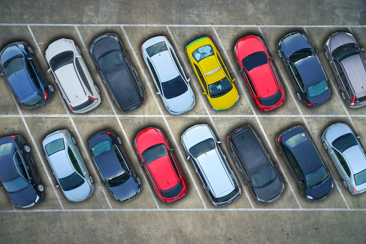 Aerial view of cars in a parking lot.