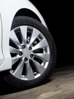 Alloy wheels of a white car are turning on the cement road of parking lot, How To Mark Tires For Rotation?